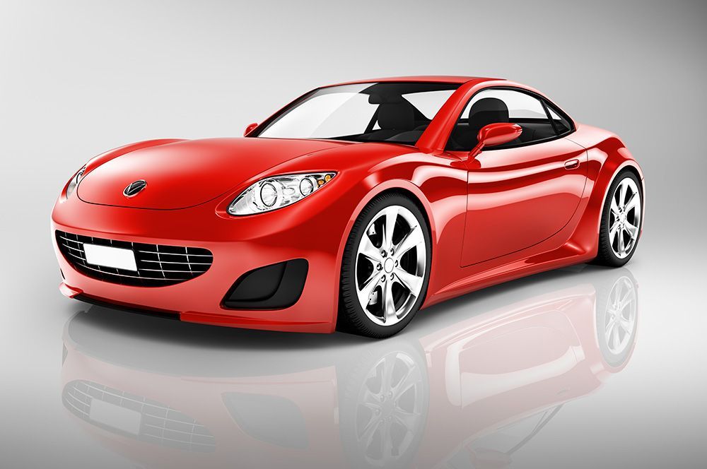 Un coche deportivo rojo está estacionado sobre una superficie blanca.