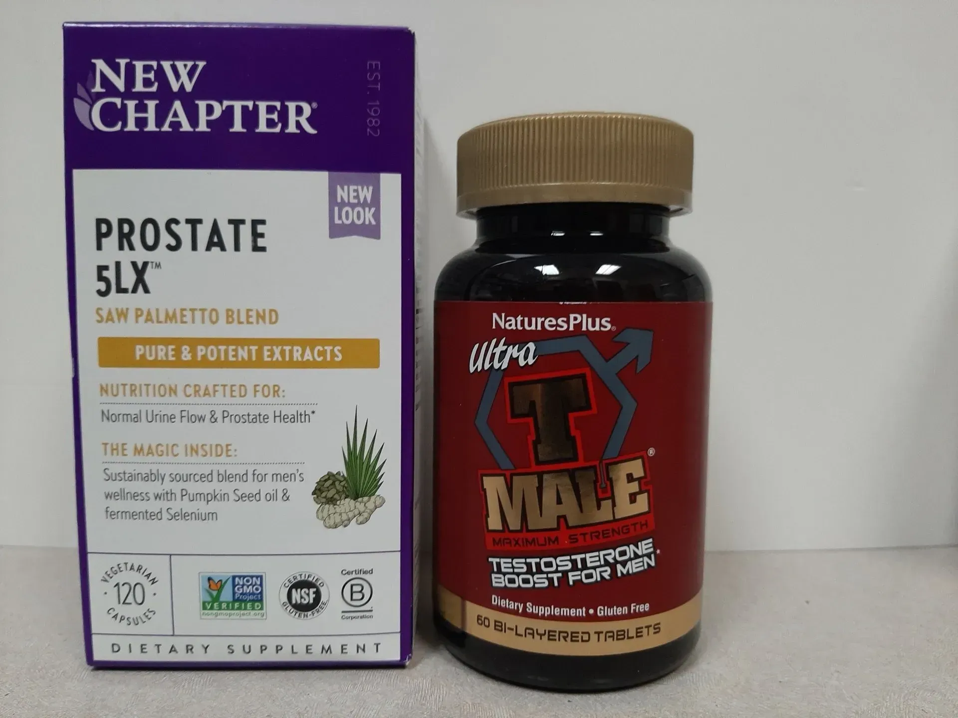 New Chapter Prostate 5LX supplement box next to a bottle of Nature's Plus Ultra T-Male testosterone booster.