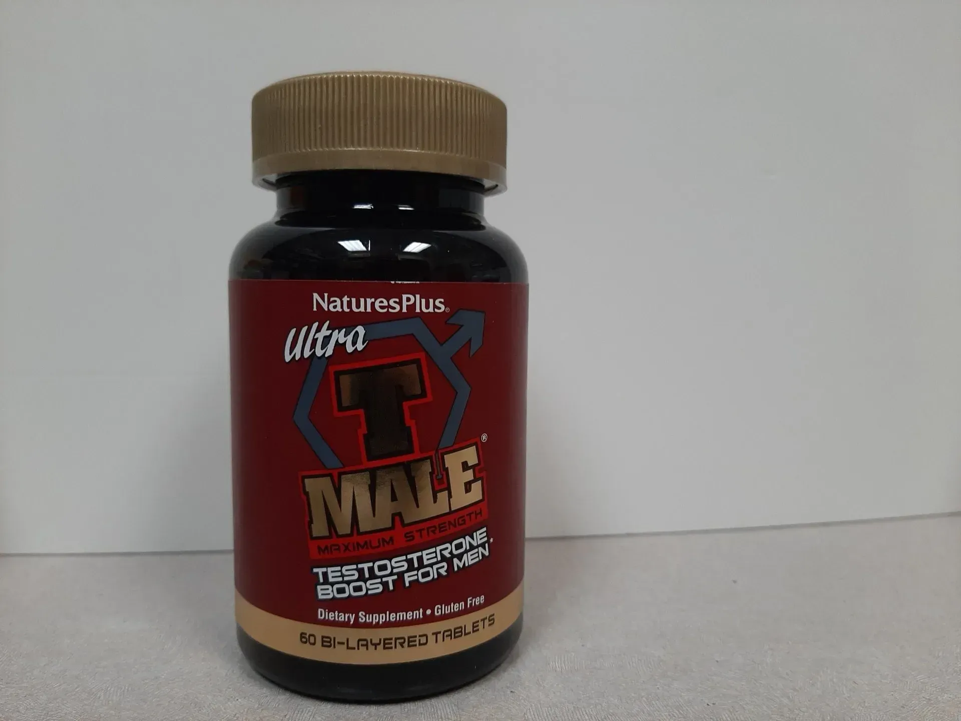 A bottle of NaturesPlus Ultra T Male testosterone booster supplement.