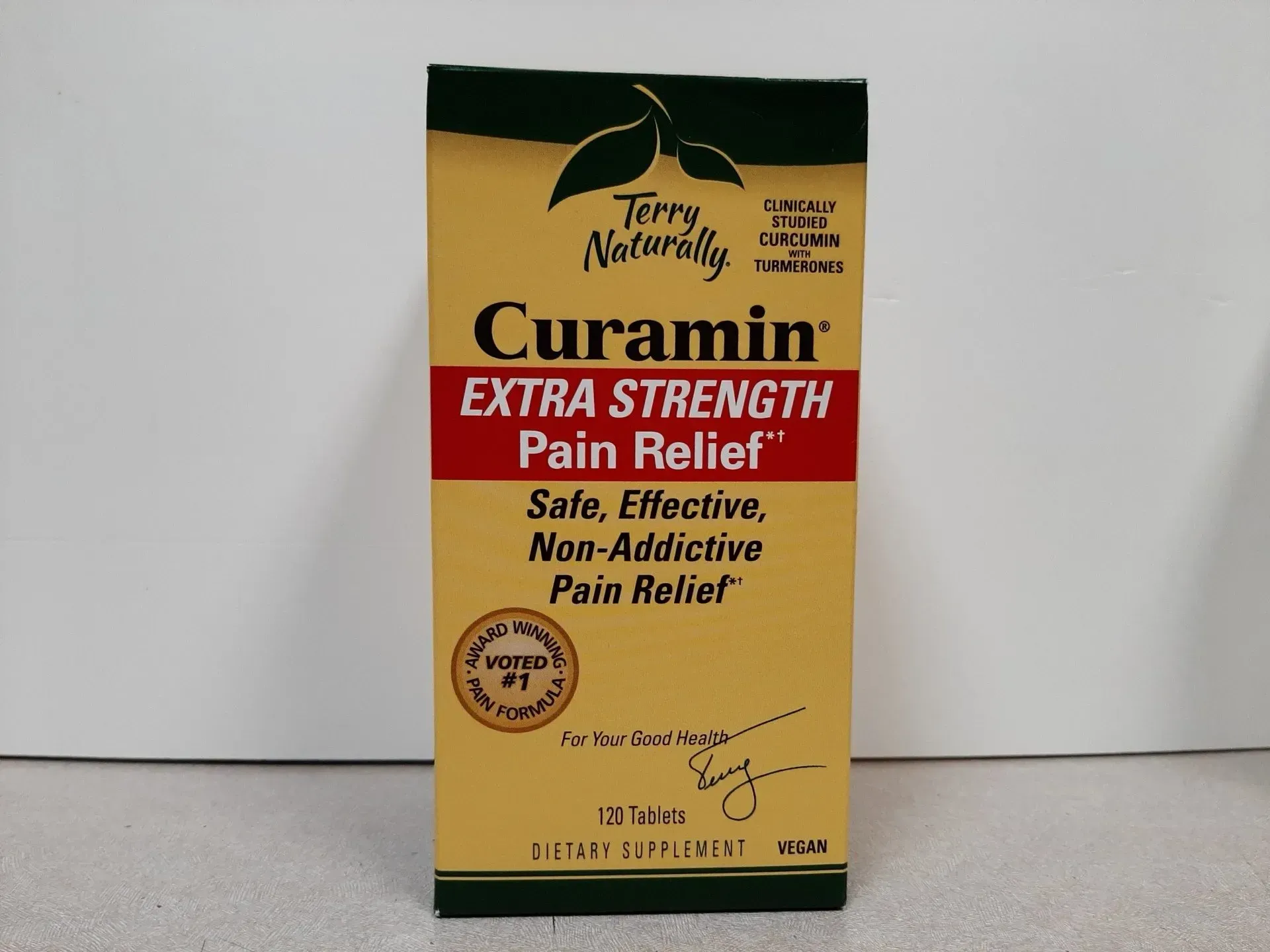 A box of Terry Naturally Curamin Extra Strength Pain Relief dietary supplement on a plain surface.