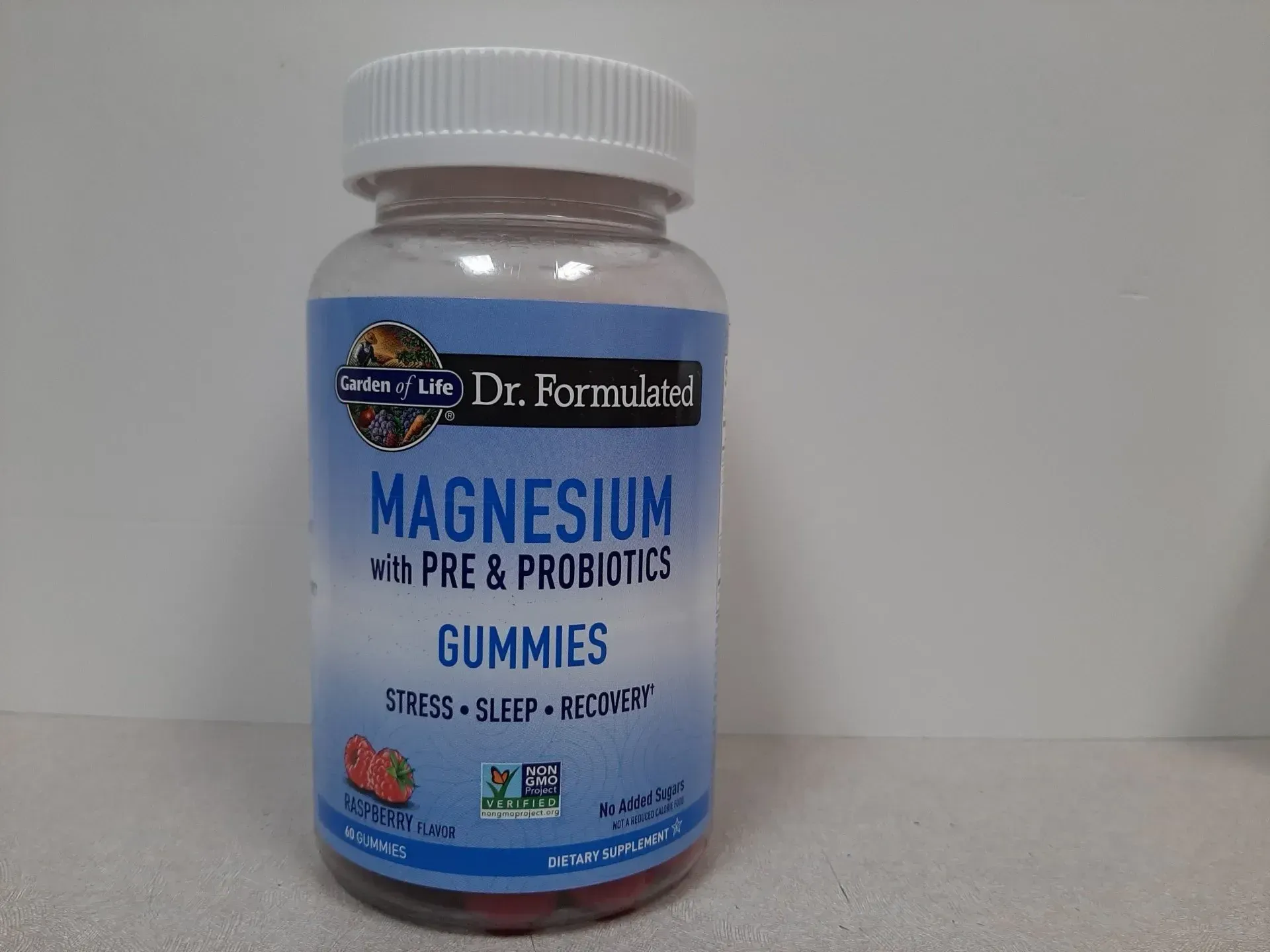 A bottle of Garden of Life Dr. Formulated Magnesium with Pre & Probiotics Gummies on a light surface.