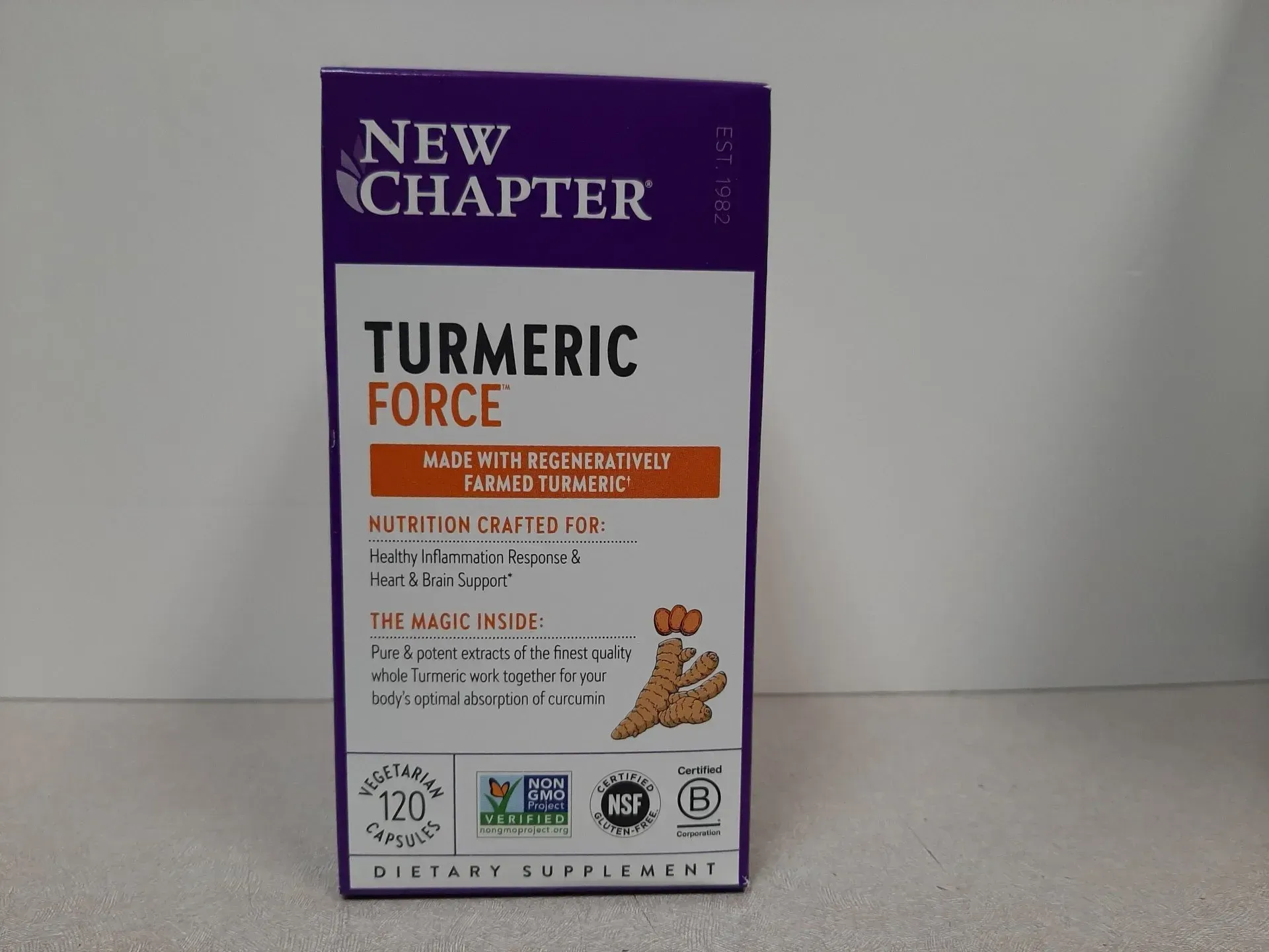 New Chapter Turmeric Force dietary supplement box, 120 capsules, featuring turmeric root illustration on a purple background.