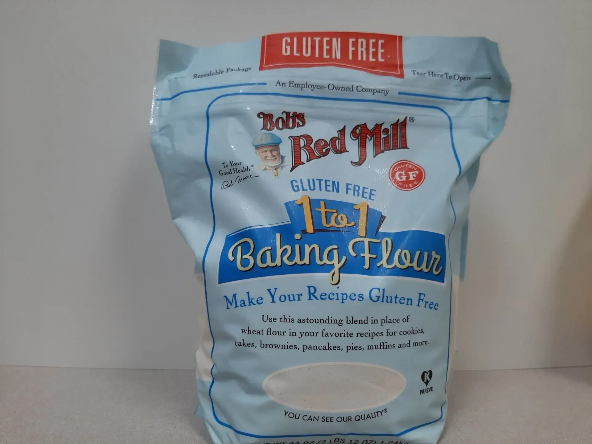 A bag of Bob's Red Mill Gluten Free 1 to 1 Baking Flour against a white background.
