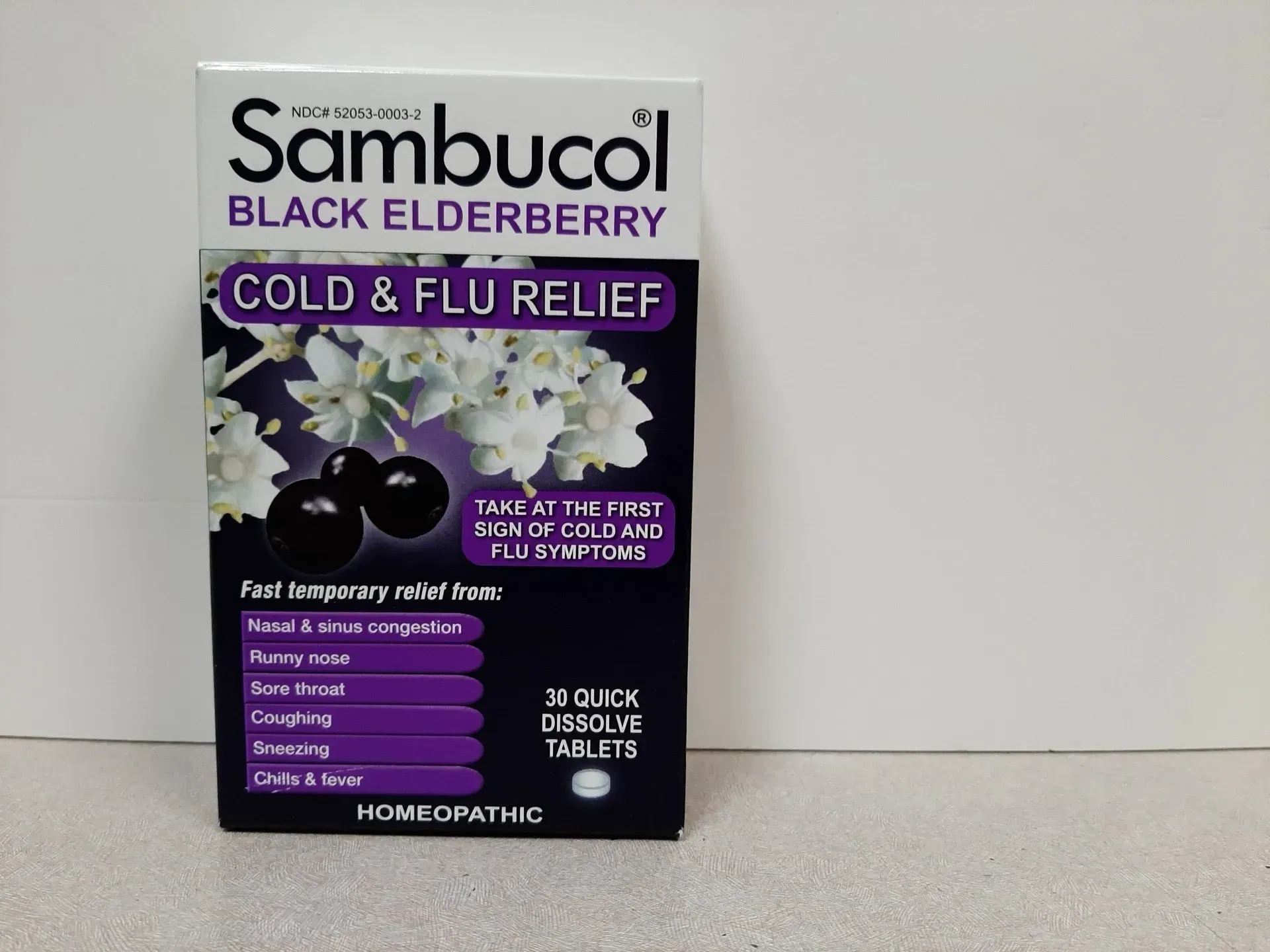 A black box of Sambucol Black Elderberry Cold & Flu Relief quick dissolve homeopathic tablets.