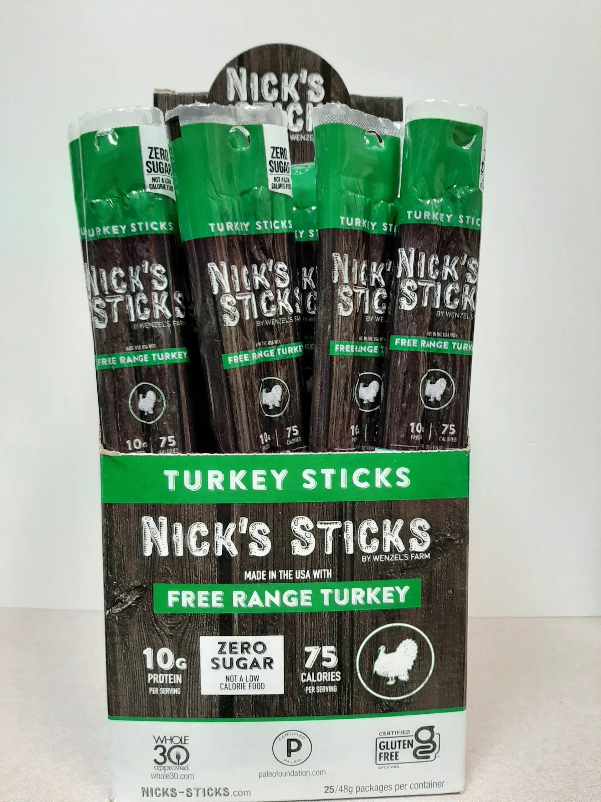 A display box of Nick's Sticks Free Range Turkey snack sticks, featuring green branding and nutritional information.