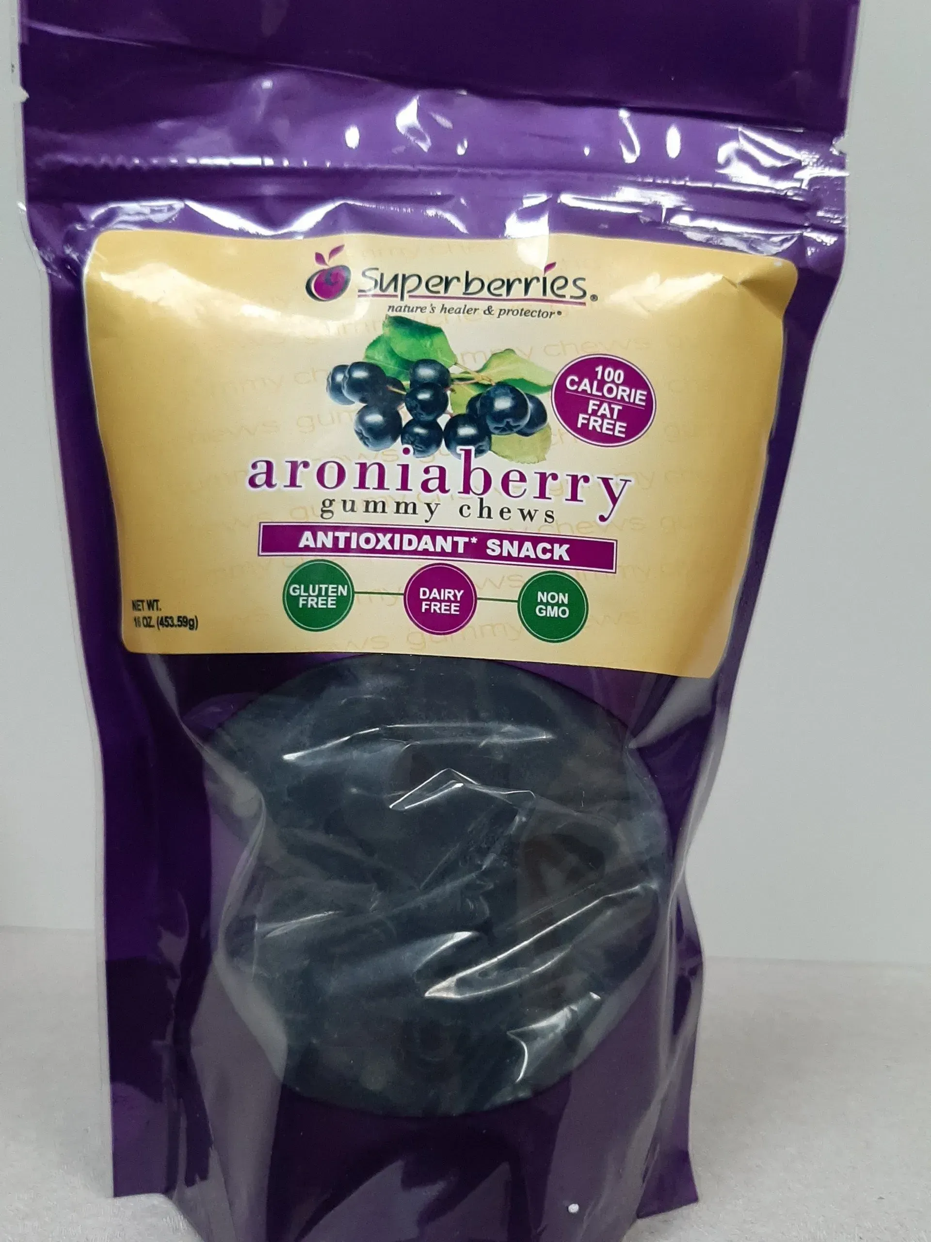 A stand-up pouch of Superberries Aroniaberry gummy chews with purple packaging and a beige label.