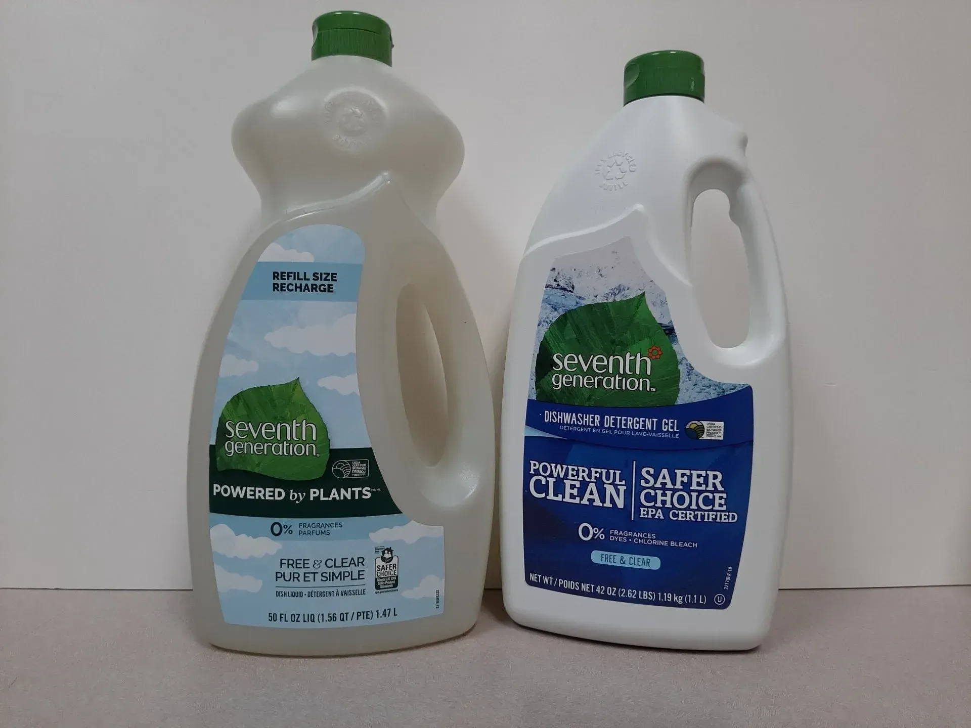 Two bottles of Seventh Generation dish soap stand side-by-side on a plain surface against a white background.