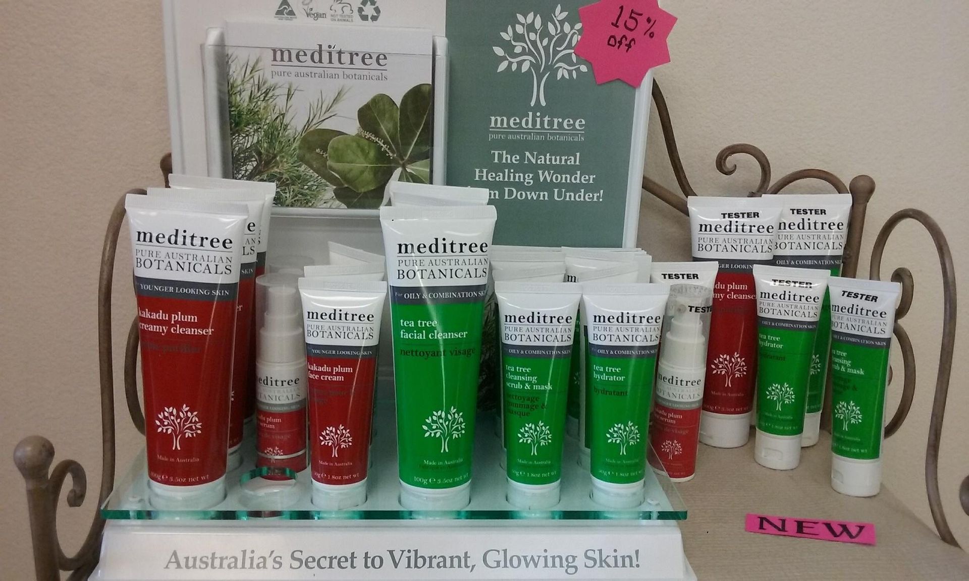 A retail display rack featuring various Meditree skincare tubes in red and green packaging with signage.