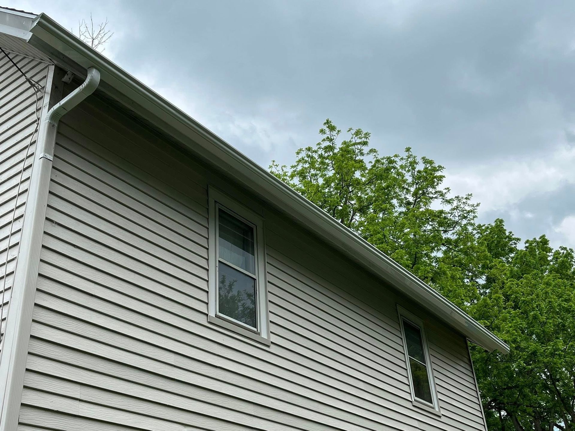 New gutters installed on yellow house