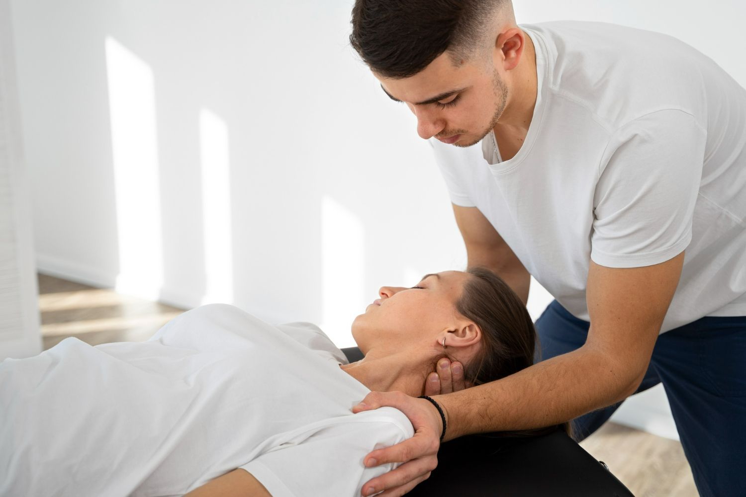 A man is giving a woman a massage on a table.