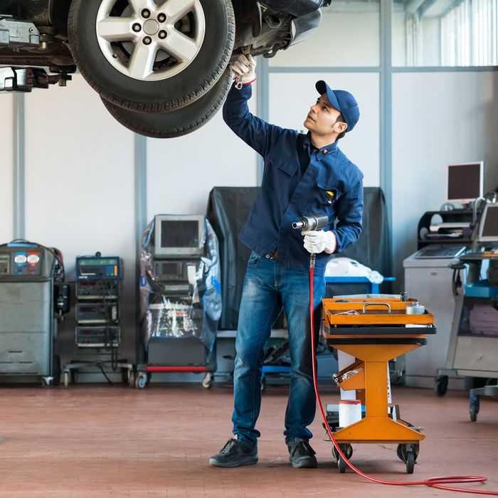 Mechanic Inspecting Car — Milwaukee, WI — Mufflers Plus Inc