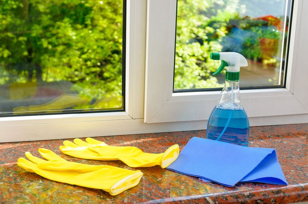 A Pair Of Yellow Gloves , A Spray Bottle , And A Cloth — Sunchem Quality Cleaning Products In Gympie, QLD