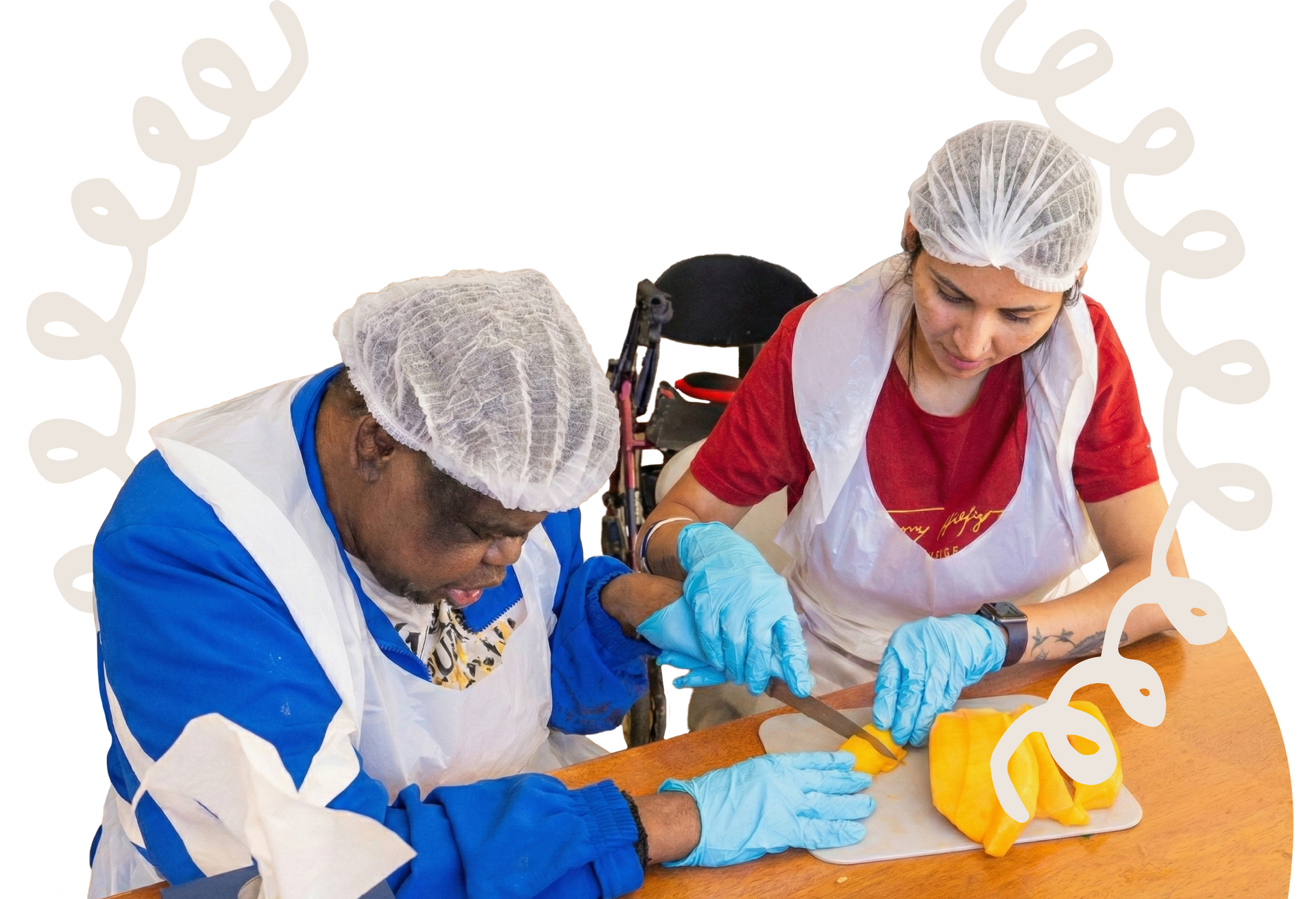 Two people wearing hairnets, aprons, and blue gloves work together to prepare food at a table.