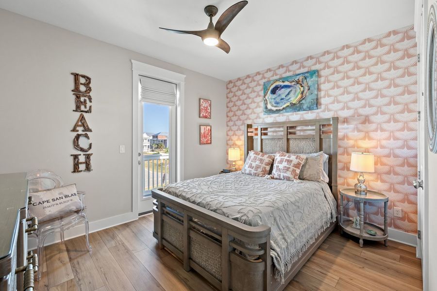 Bedroom with a bed, seashell wallpaper, and a 