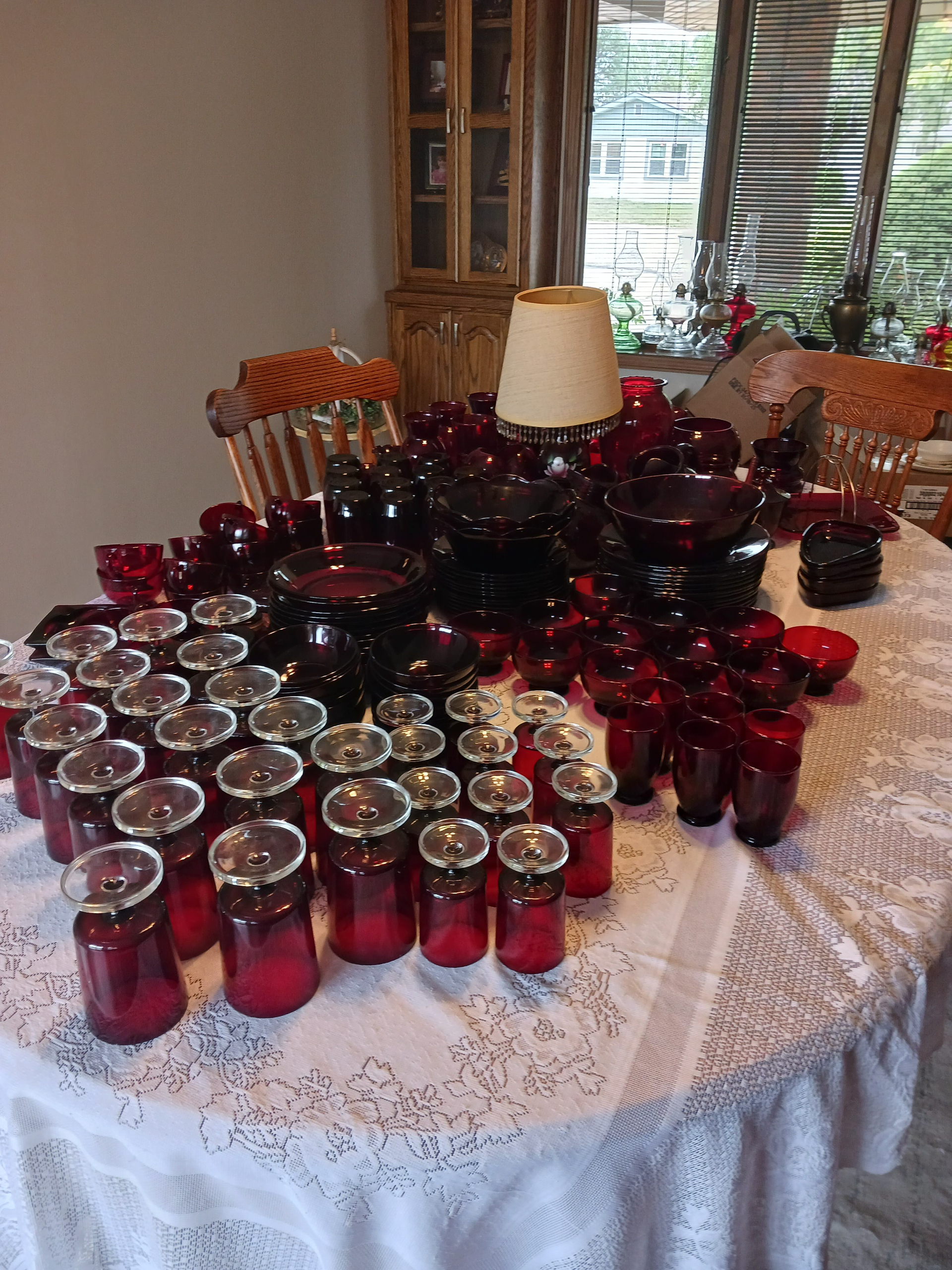 A table with a lot of red glasses on it