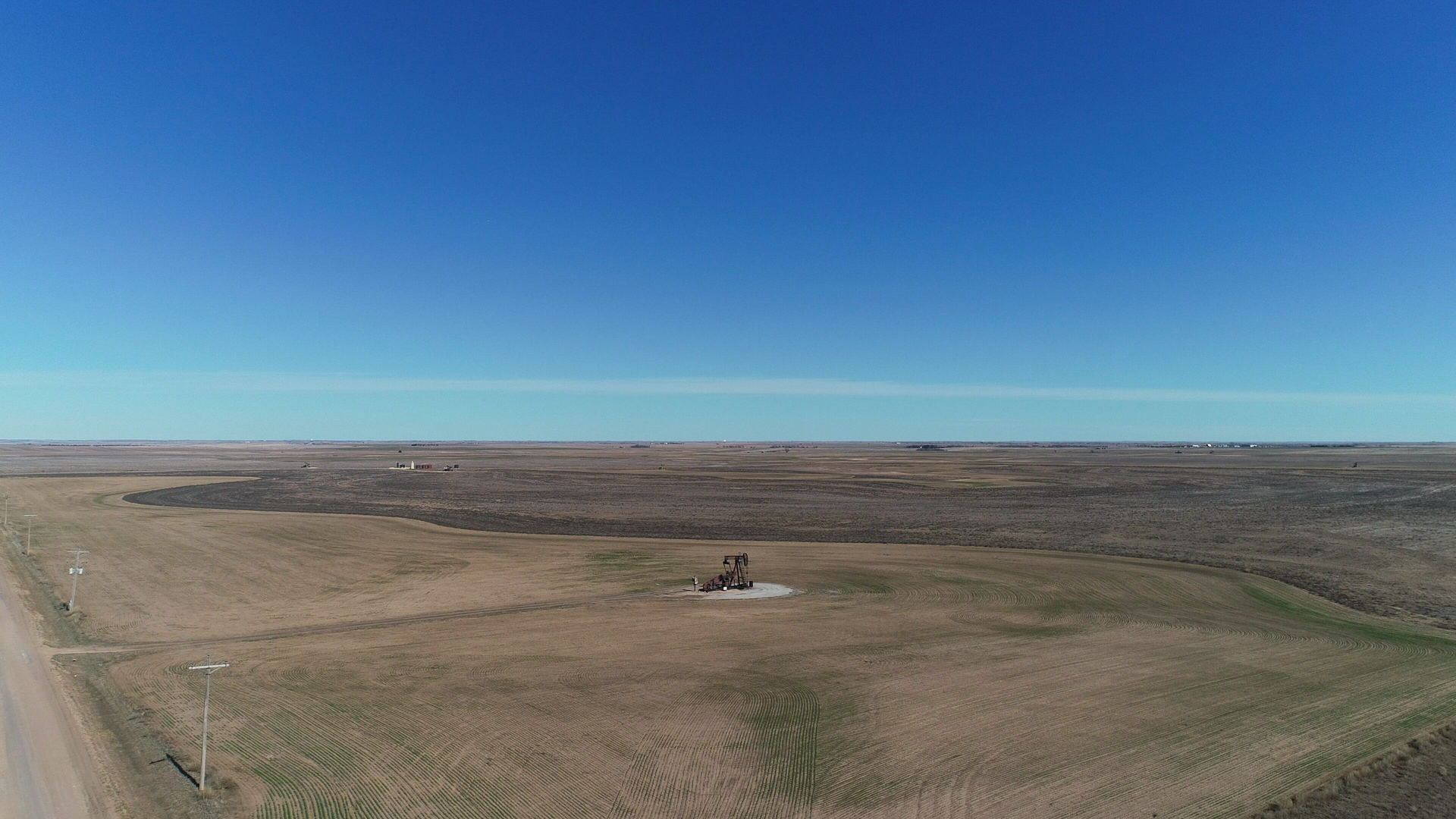 An aerial view of a field with a blue sky in the background.