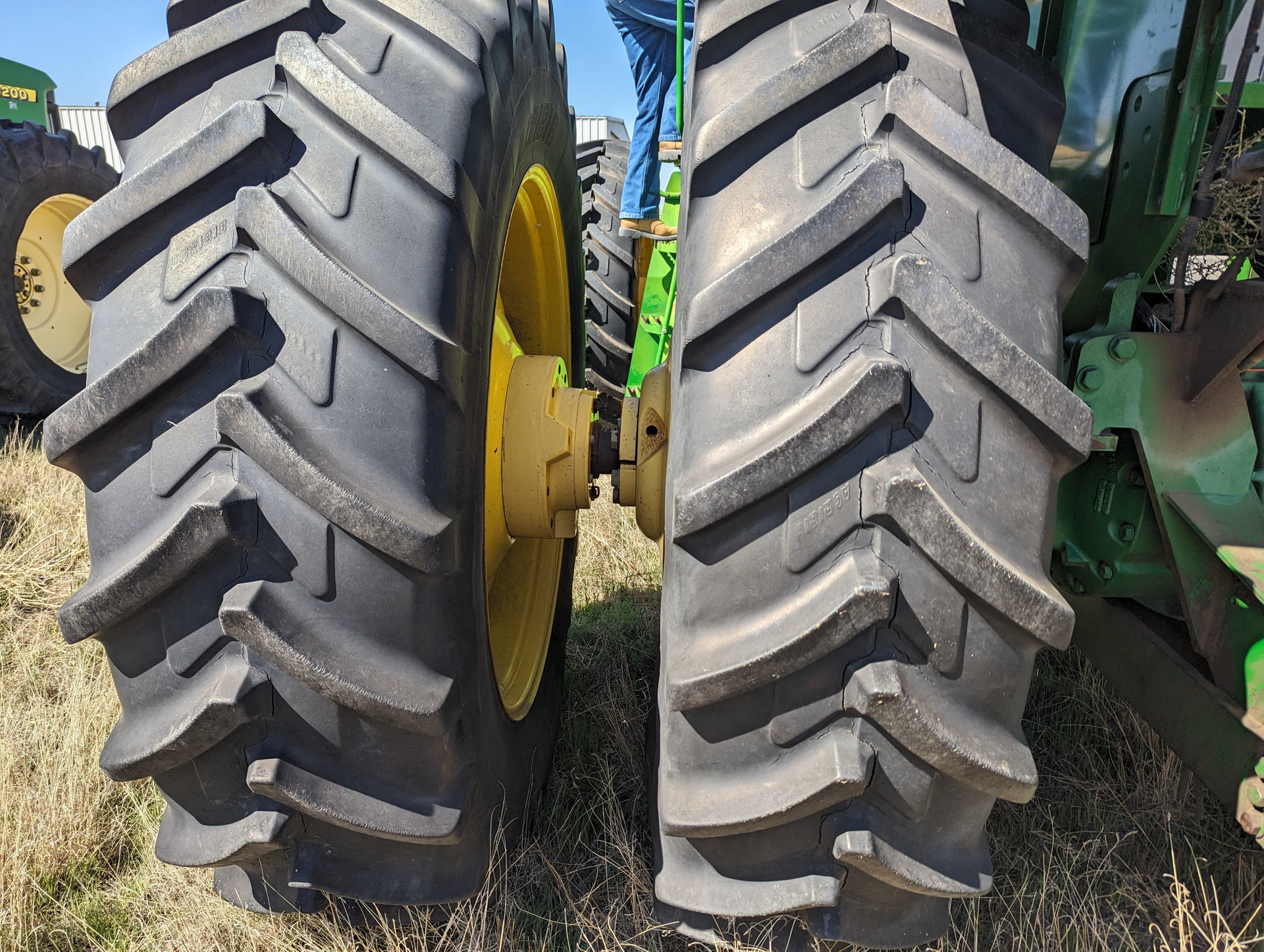 Two tractor tires are sitting next to each other in a field.