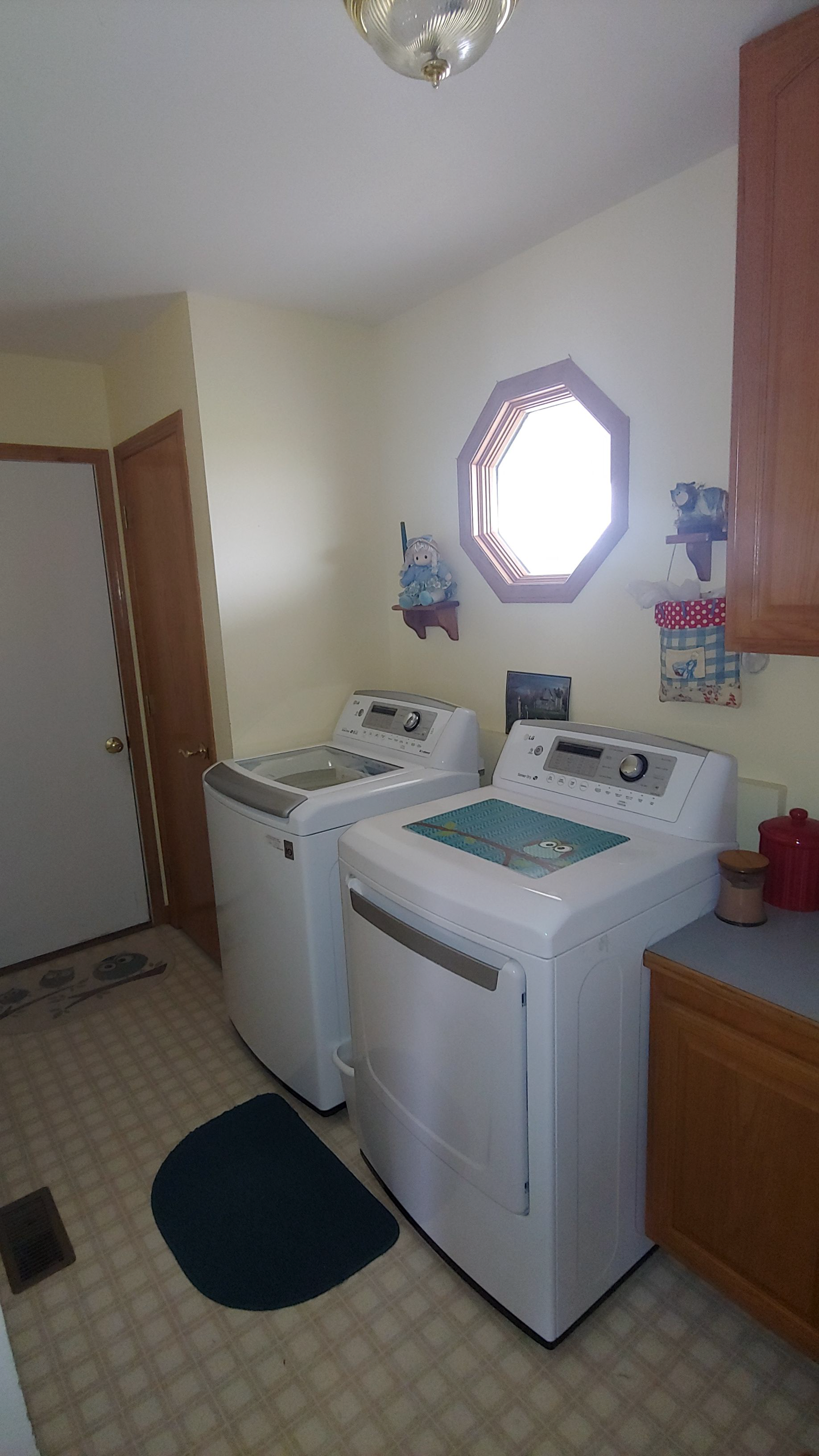 A laundry room with a washer and dryer and a window.