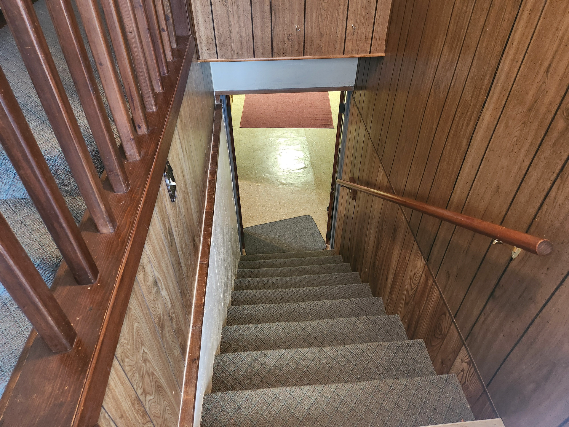 A set of stairs leading down to a basement in a house.