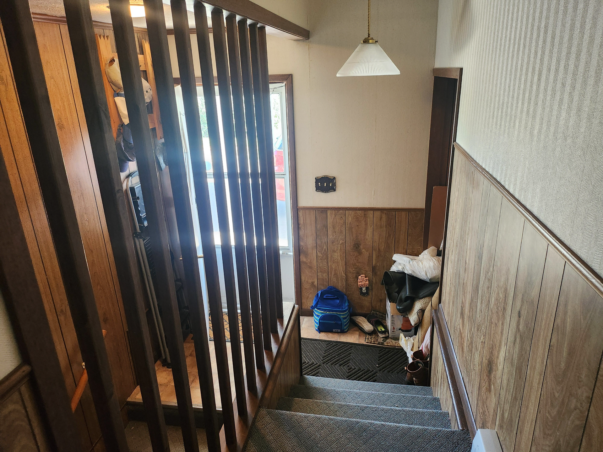 A staircase with a wooden railing leading up to the second floor of a house.
