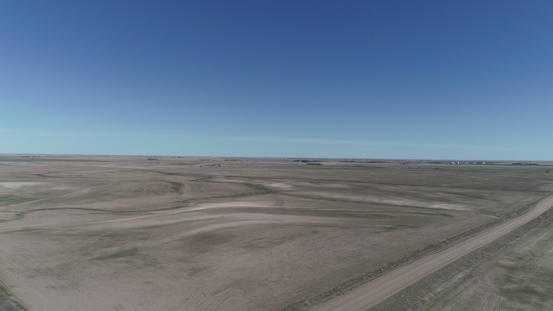 An aerial view of a dirt road in the middle of a desert.