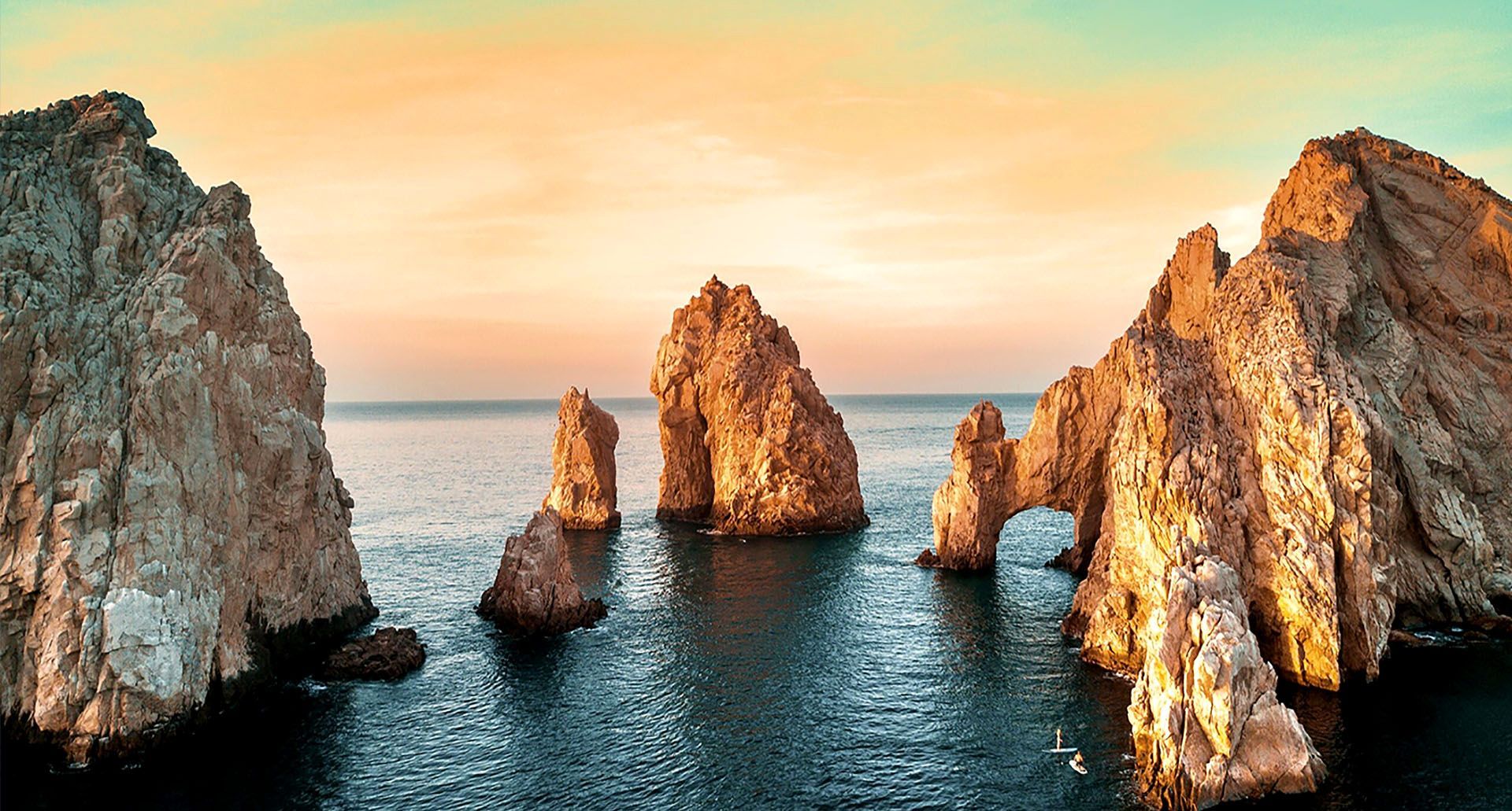 Una persona está formando un corazón con las manos frente a un edificio.