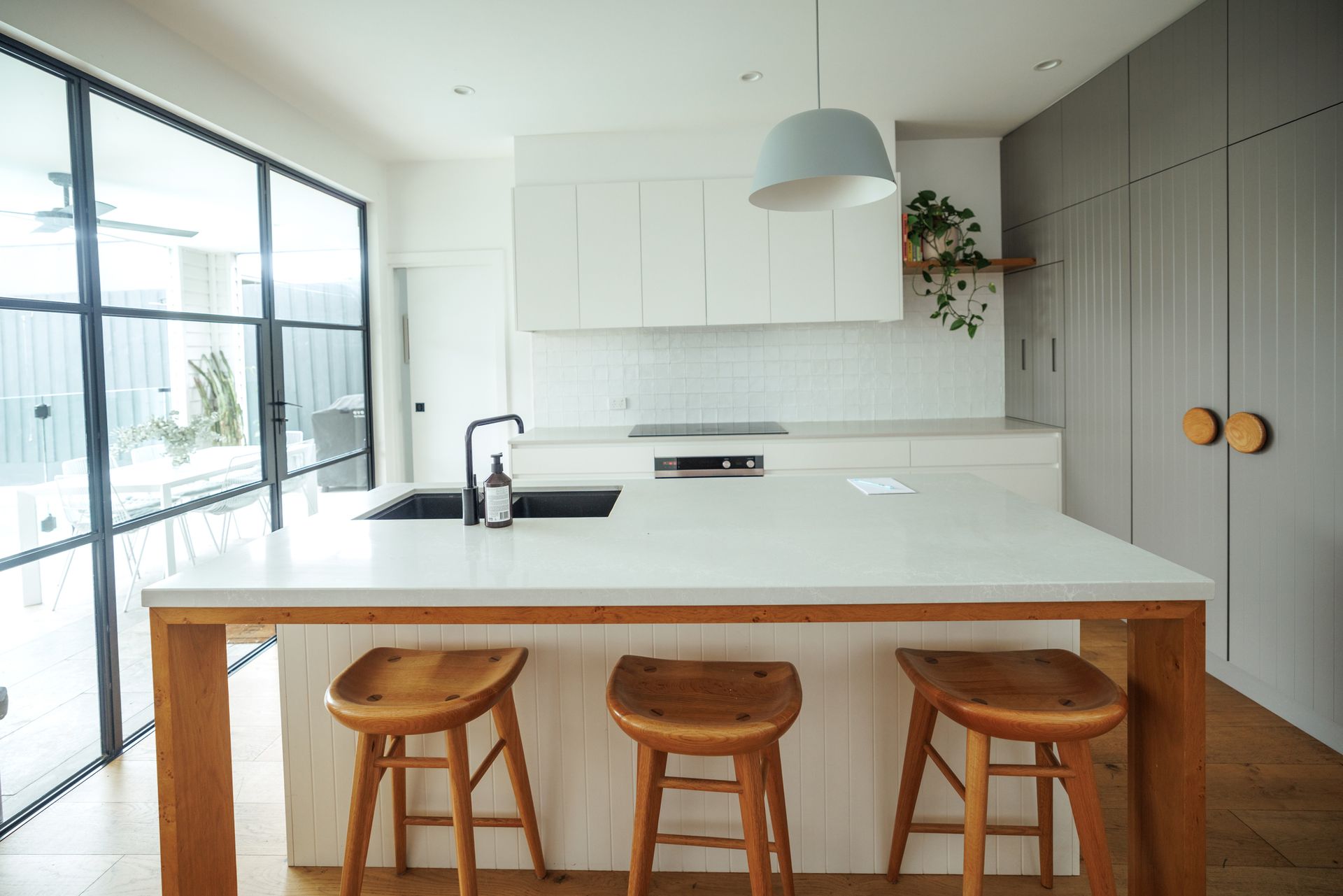 Modern kitchen with a white benchtop.