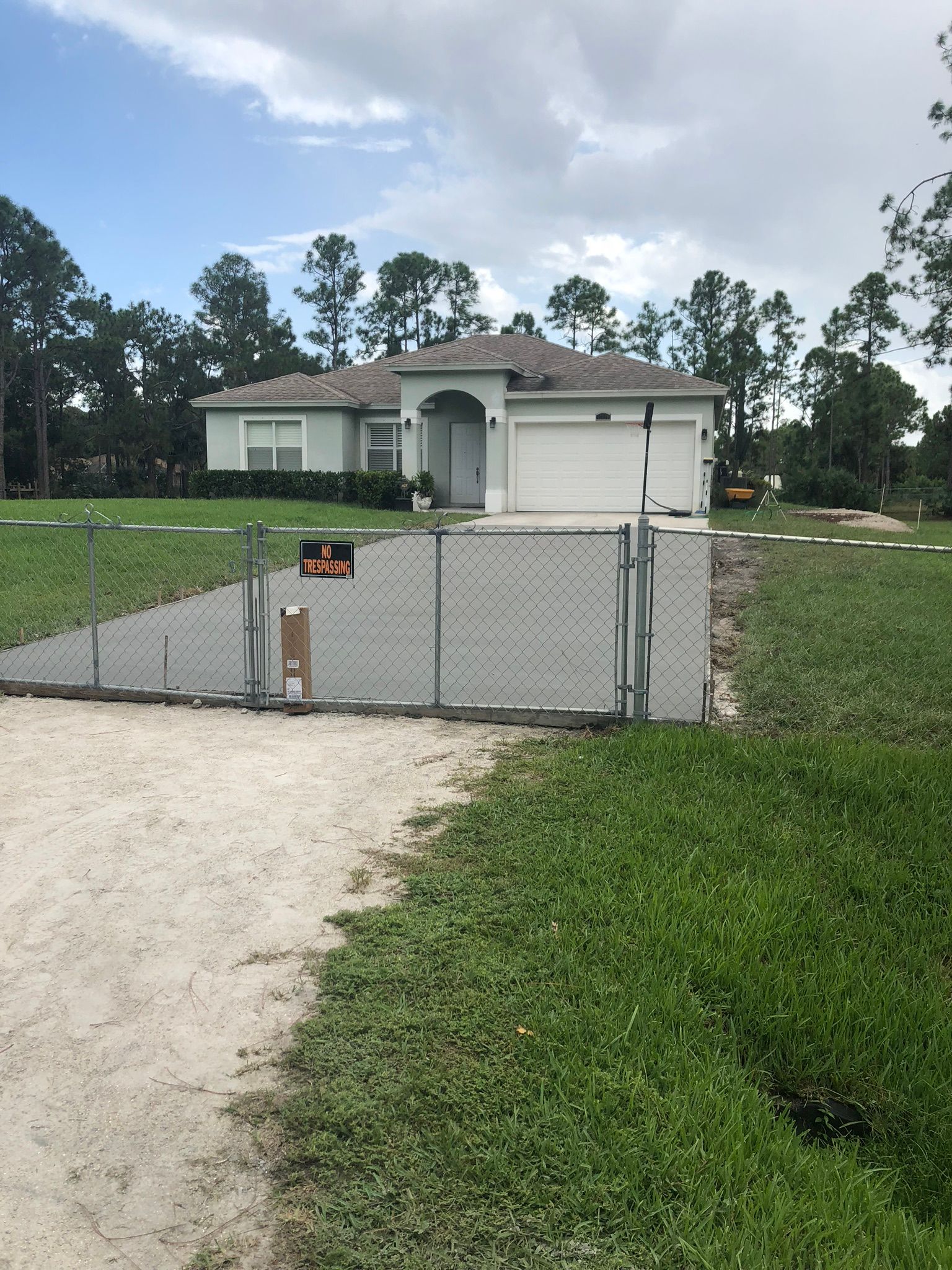 A house with a chain link fence in front of it.