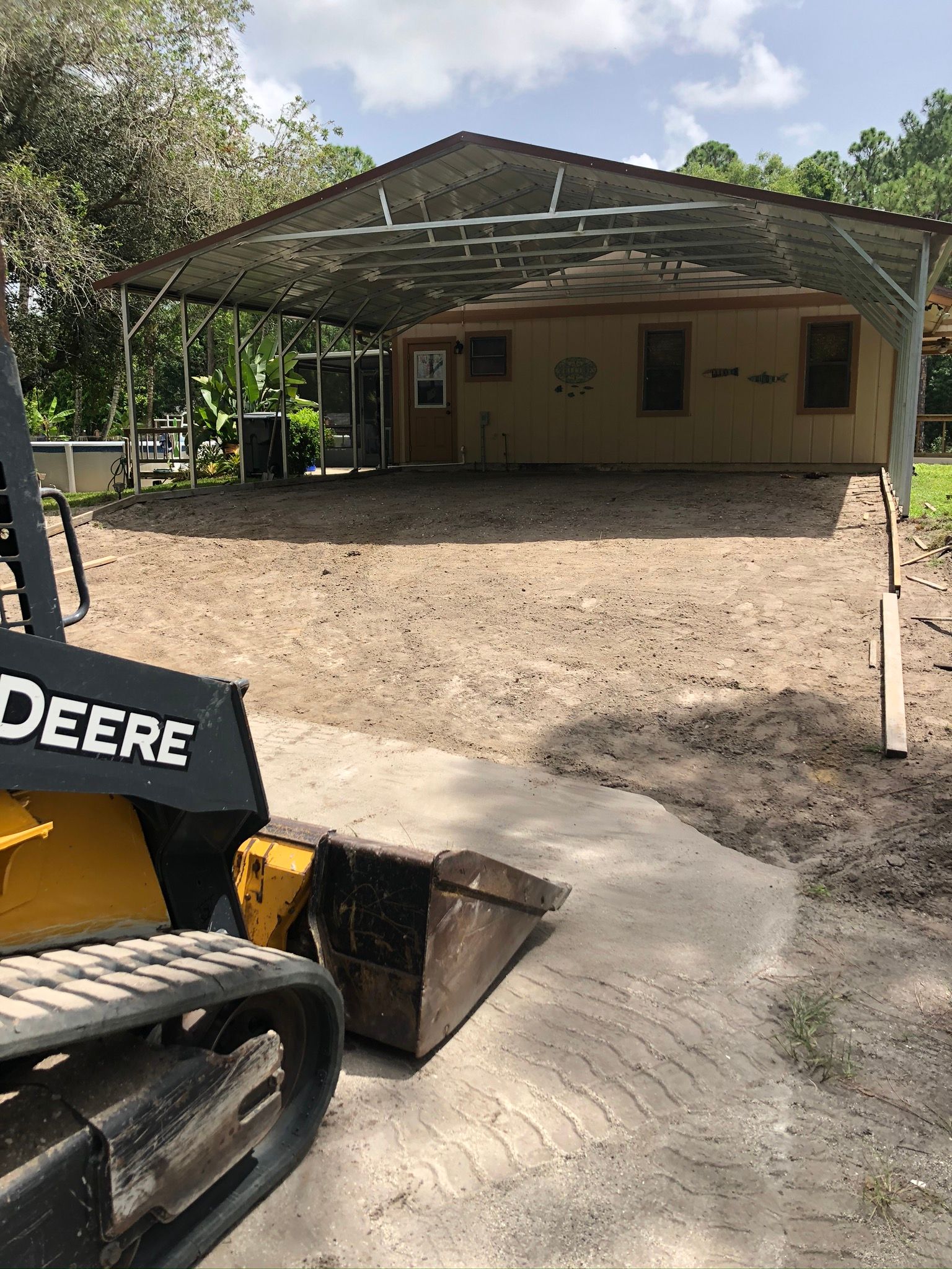 A deere bulldozer is parked in front of a building.