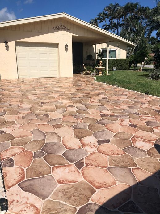 A house with a stone driveway in front of it