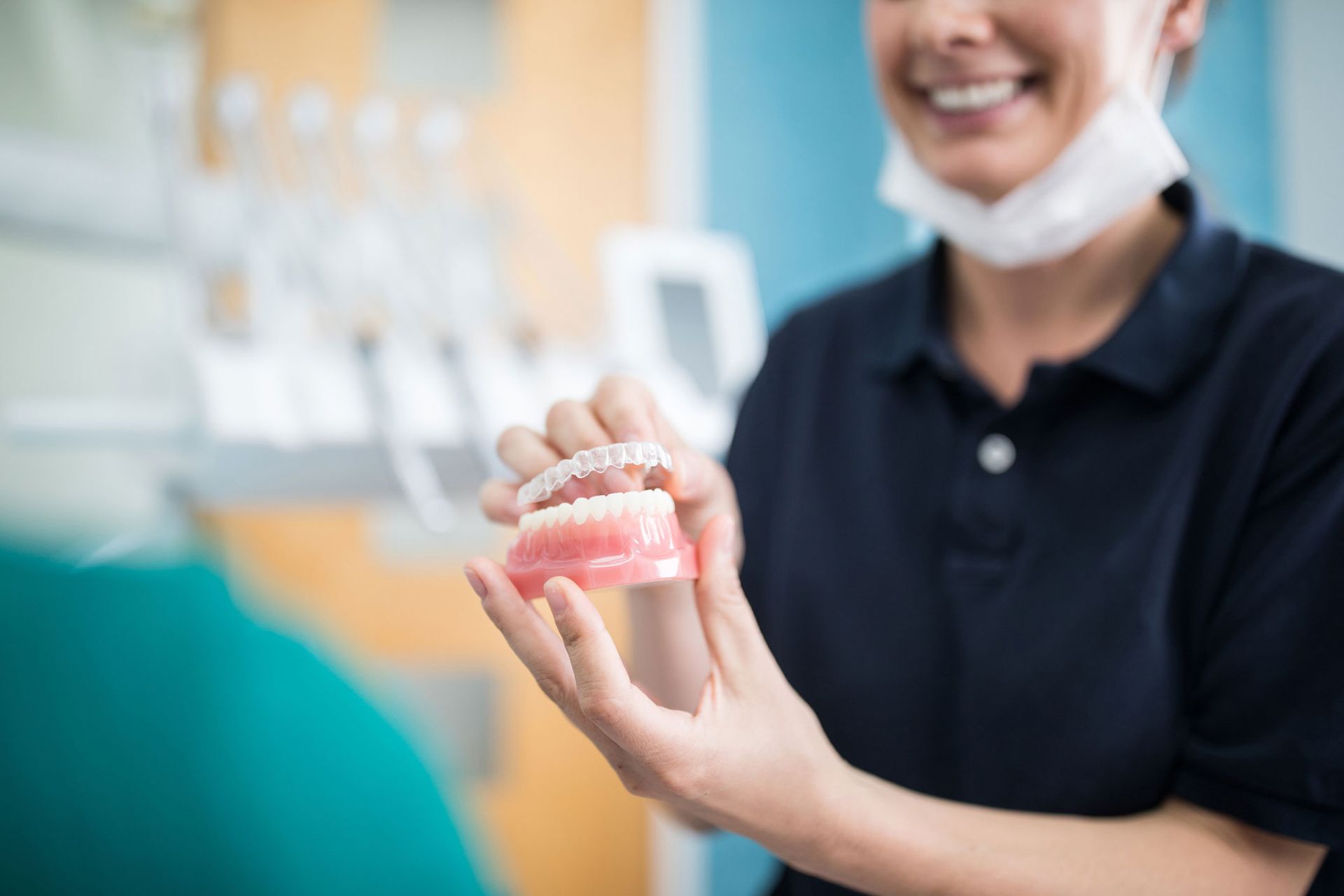 Orthodontist explaining an implant to a patient in clinic