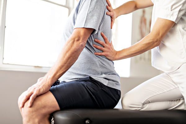 Physiotherapist treating womans back