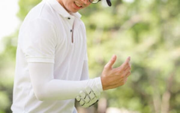 man with golfers elbow pain