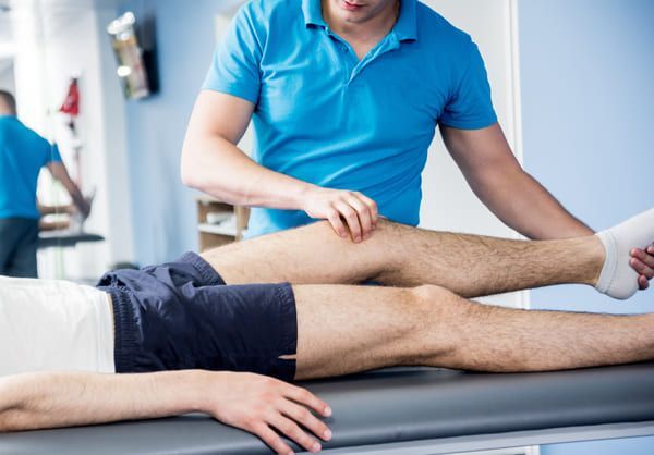 physiotherapist assessing a patient's knee