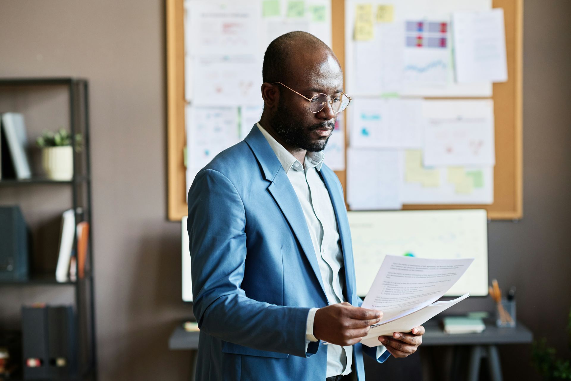 A man in a suit is holding a piece of paper in his hands.