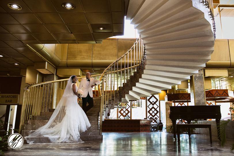 Happy Couple on Stairs at Rainbow Towers Hotel Wedding in Harare Zimbabwe