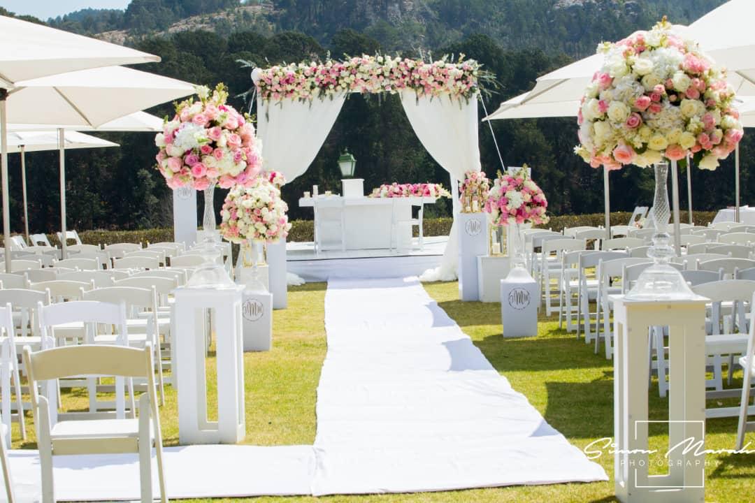 Outdoor Wedding Aisle with Flowers and Waterfront View at Nyanga Zimbabwe
