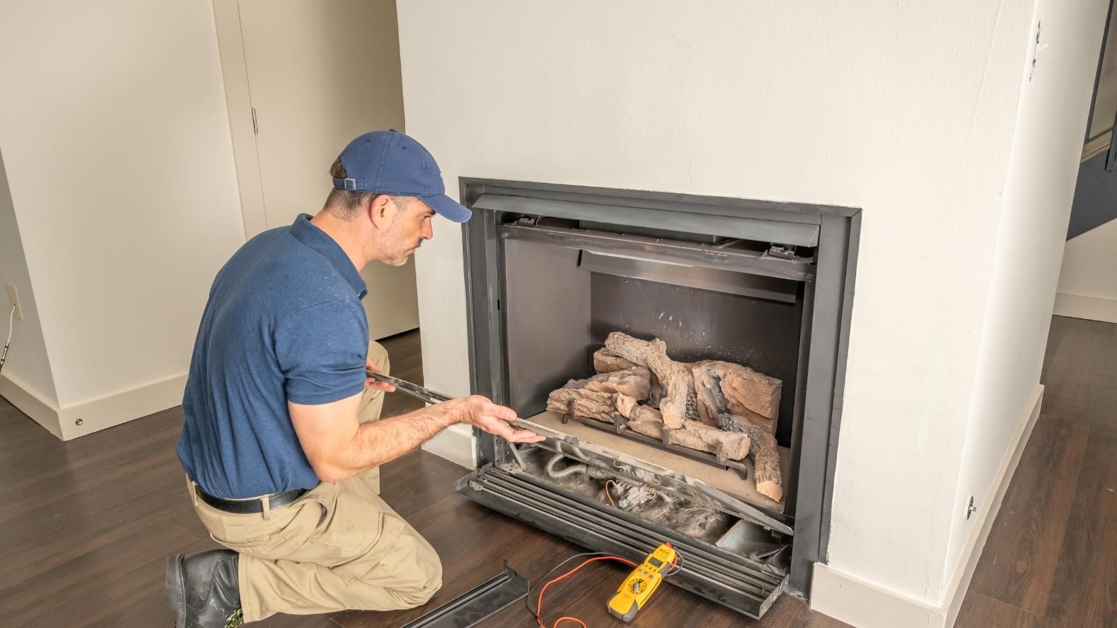 Technician servicing a gas fireplace.