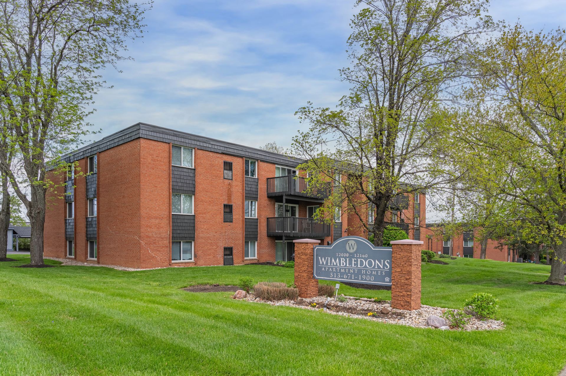 a photo of the property sign and building at The Wimbledons