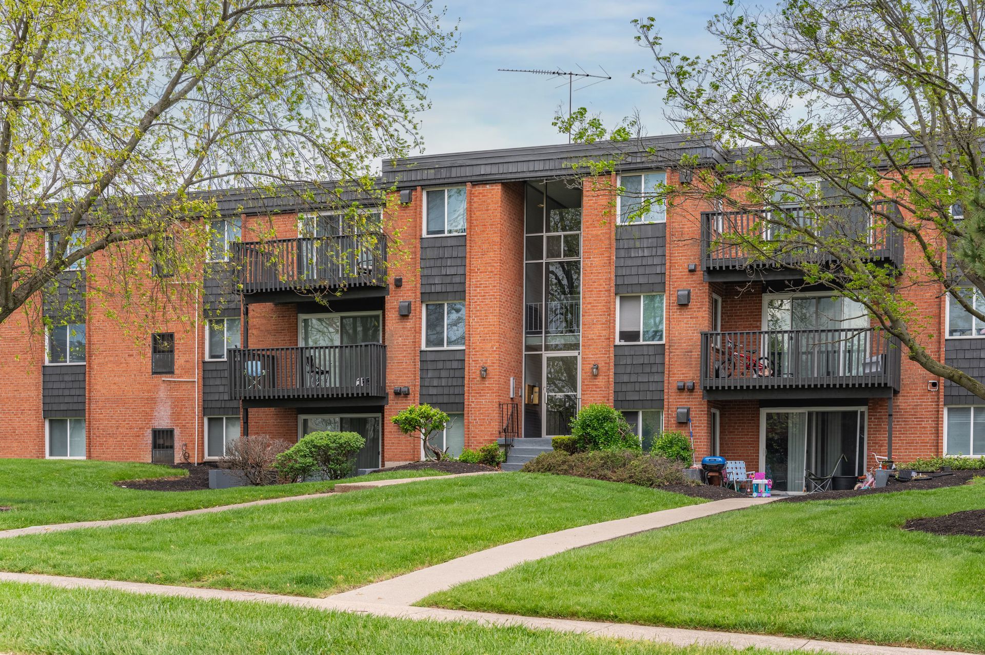 Exterior image of The Wimbledons brick building with patios and balconies