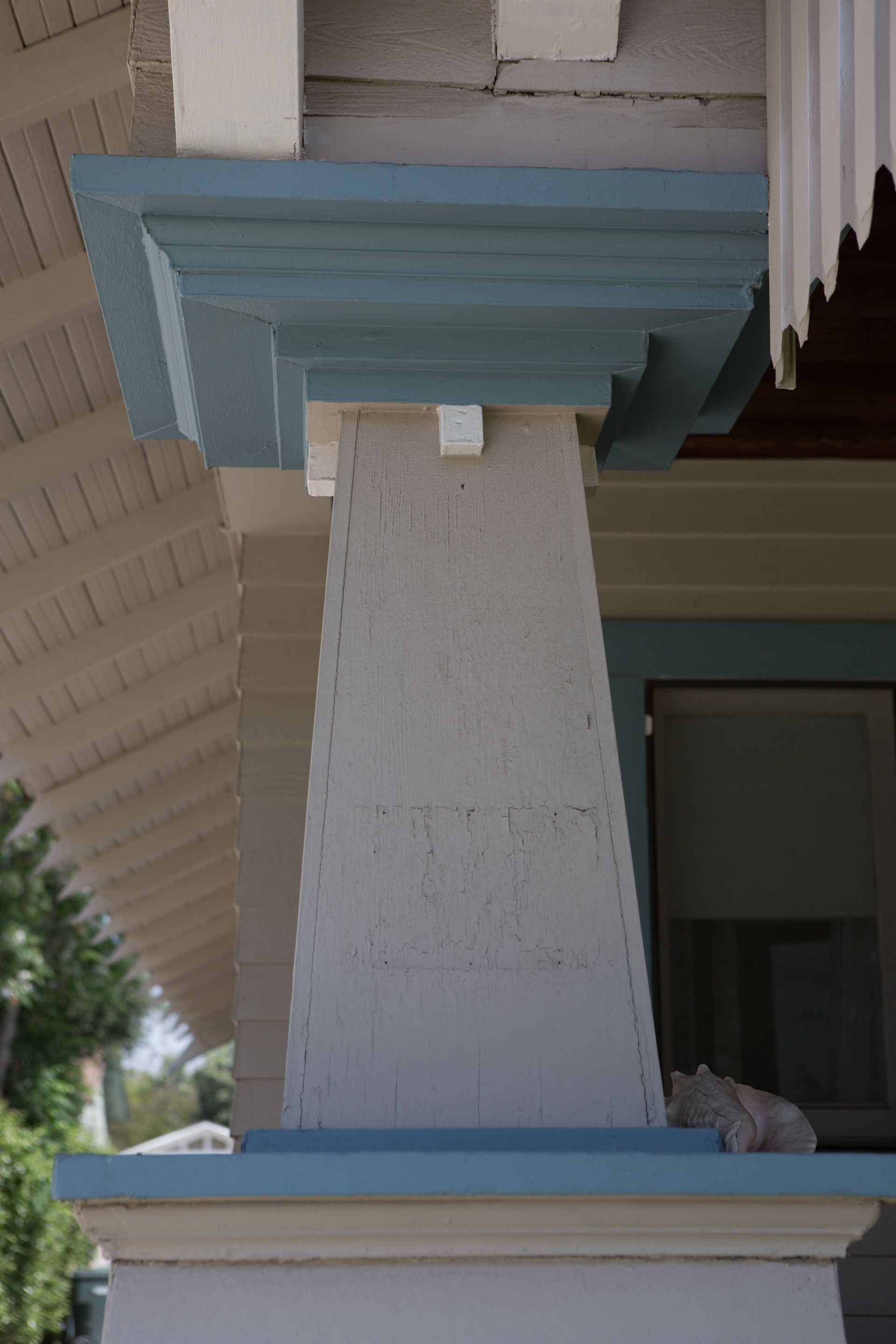 A close up of a pillar on a porch of a house.