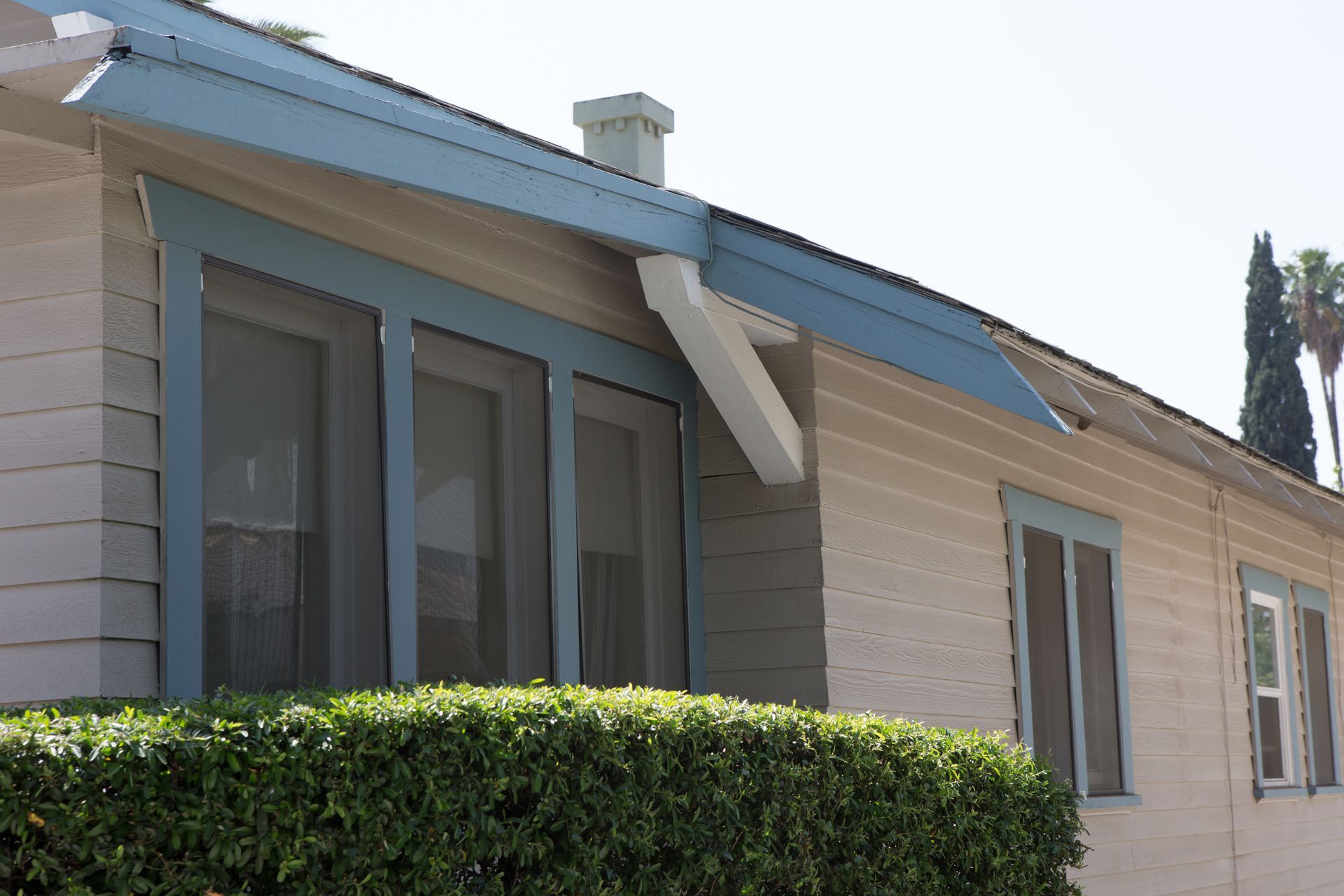 A house with a blue roof and a lot of windows