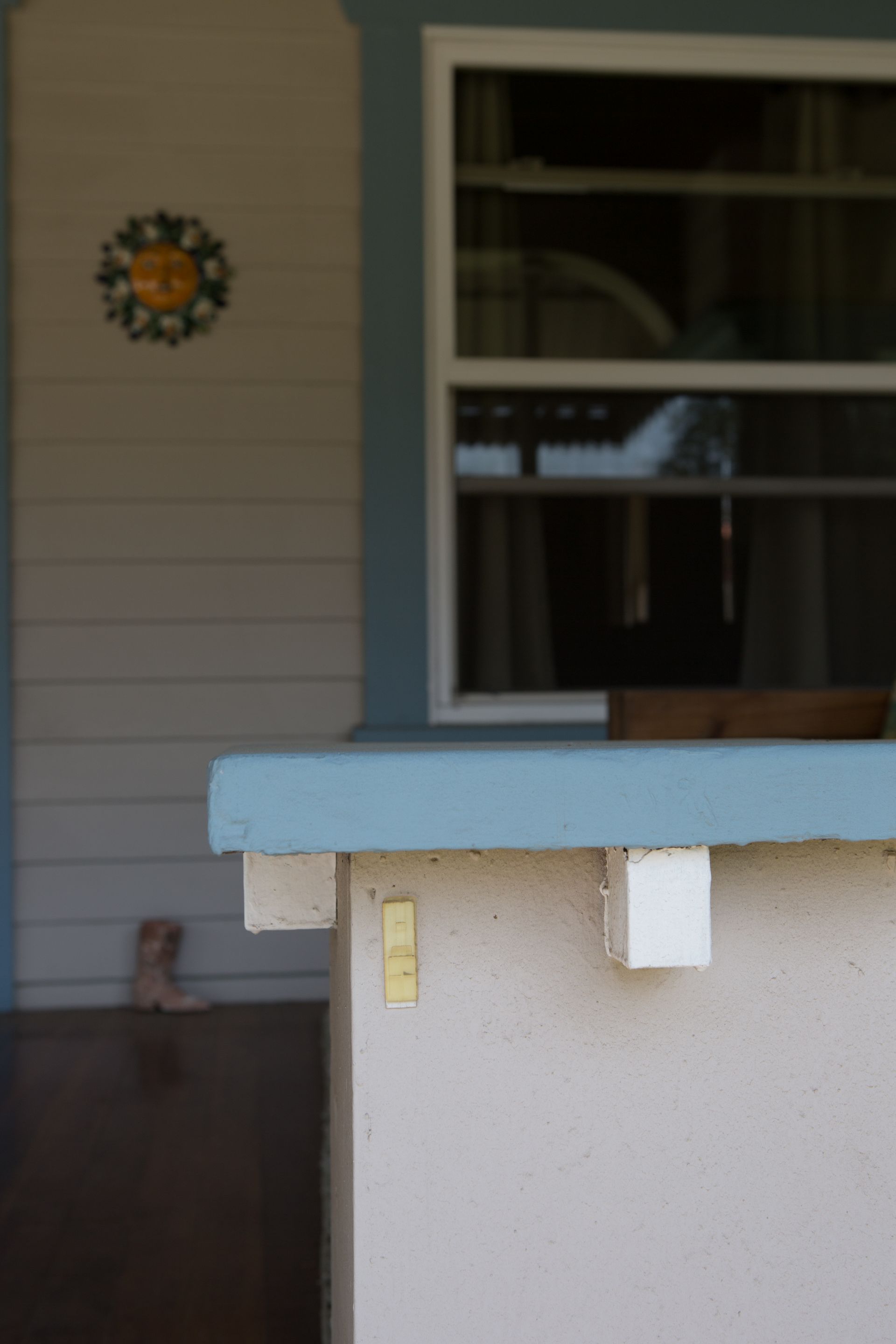 A white building with a blue roof and a window