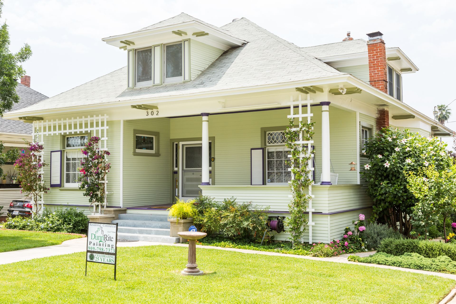 A house with a for sale sign in front of it.