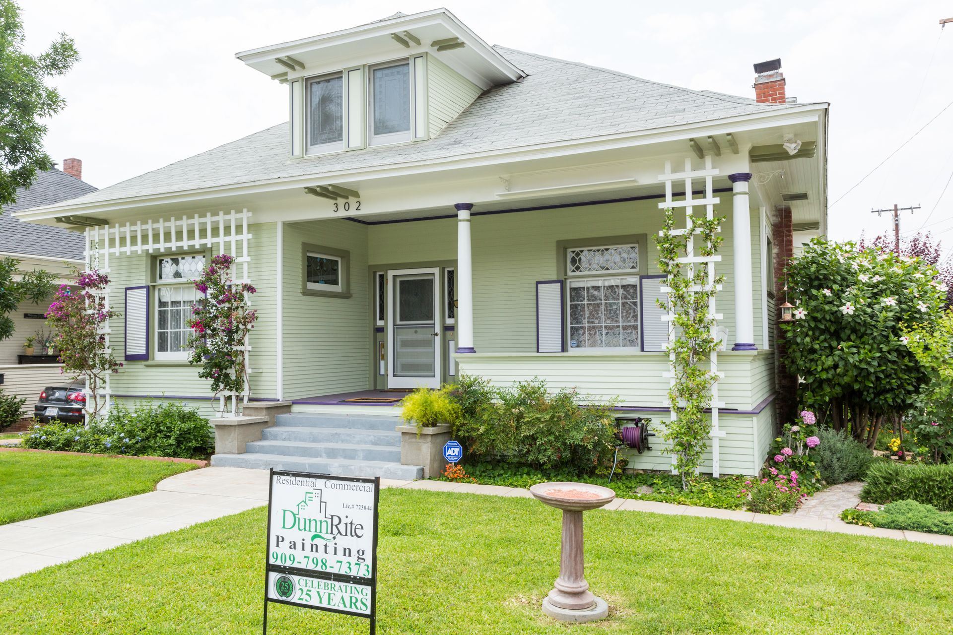A house with a for sale sign in front of it