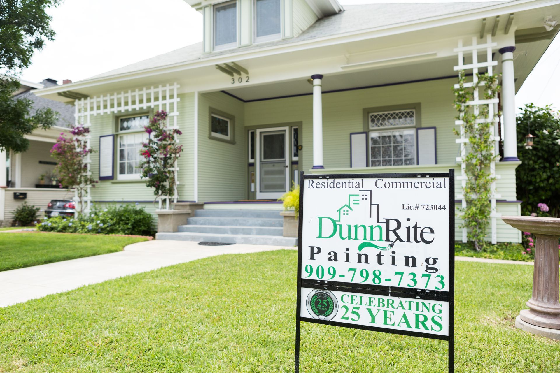 A sign for dunn rite painting is in front of a house