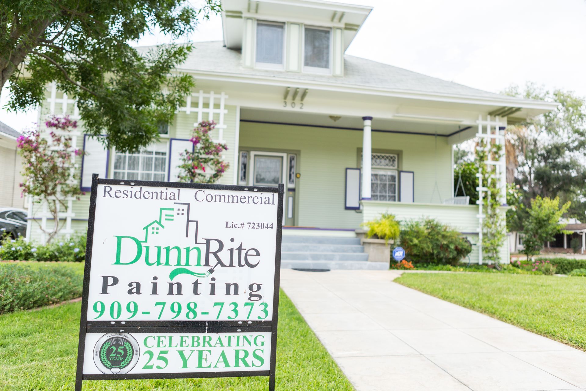 A dunrite painting sign is in front of a house