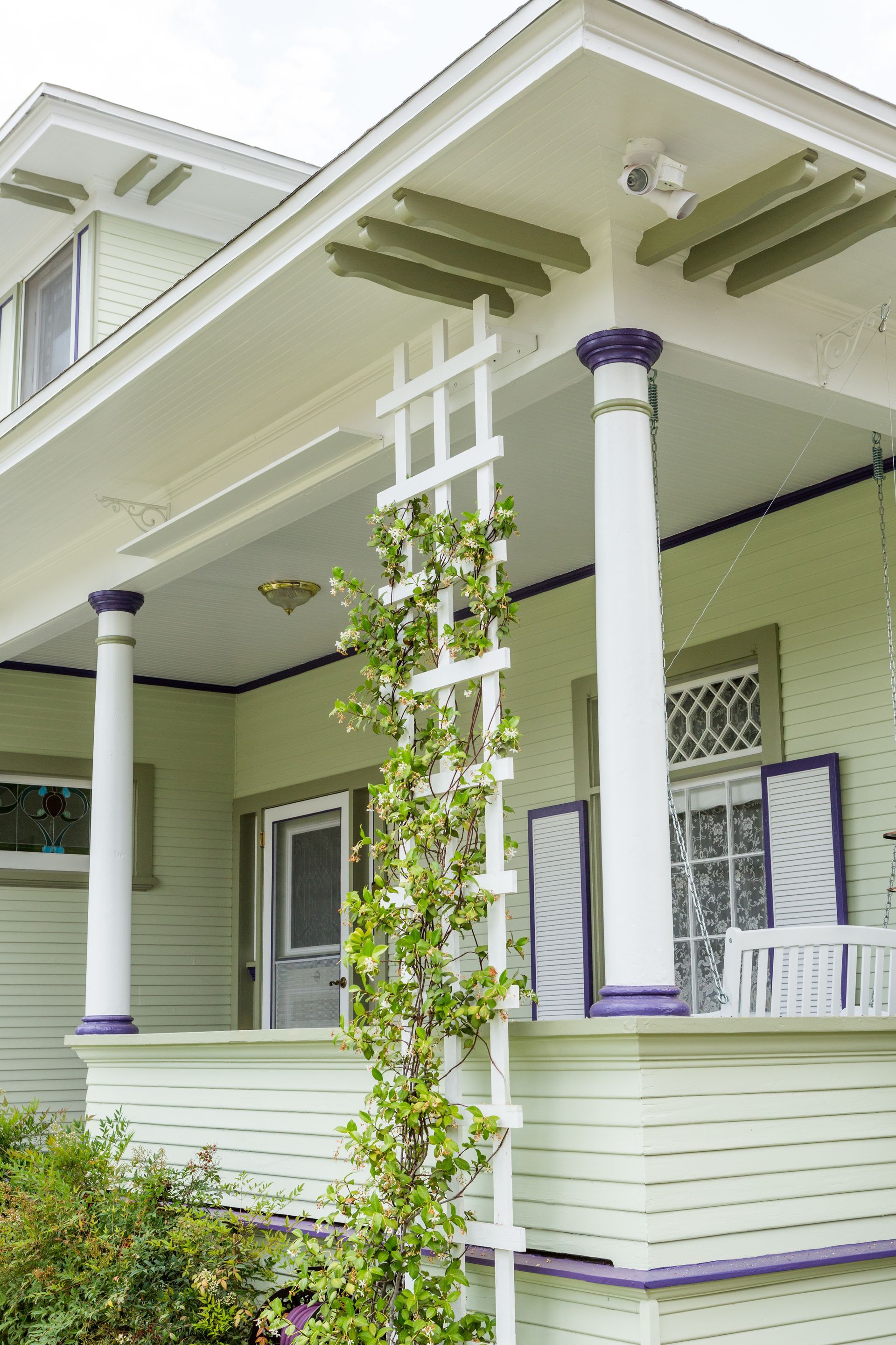 A white house with a white lattice on the porch