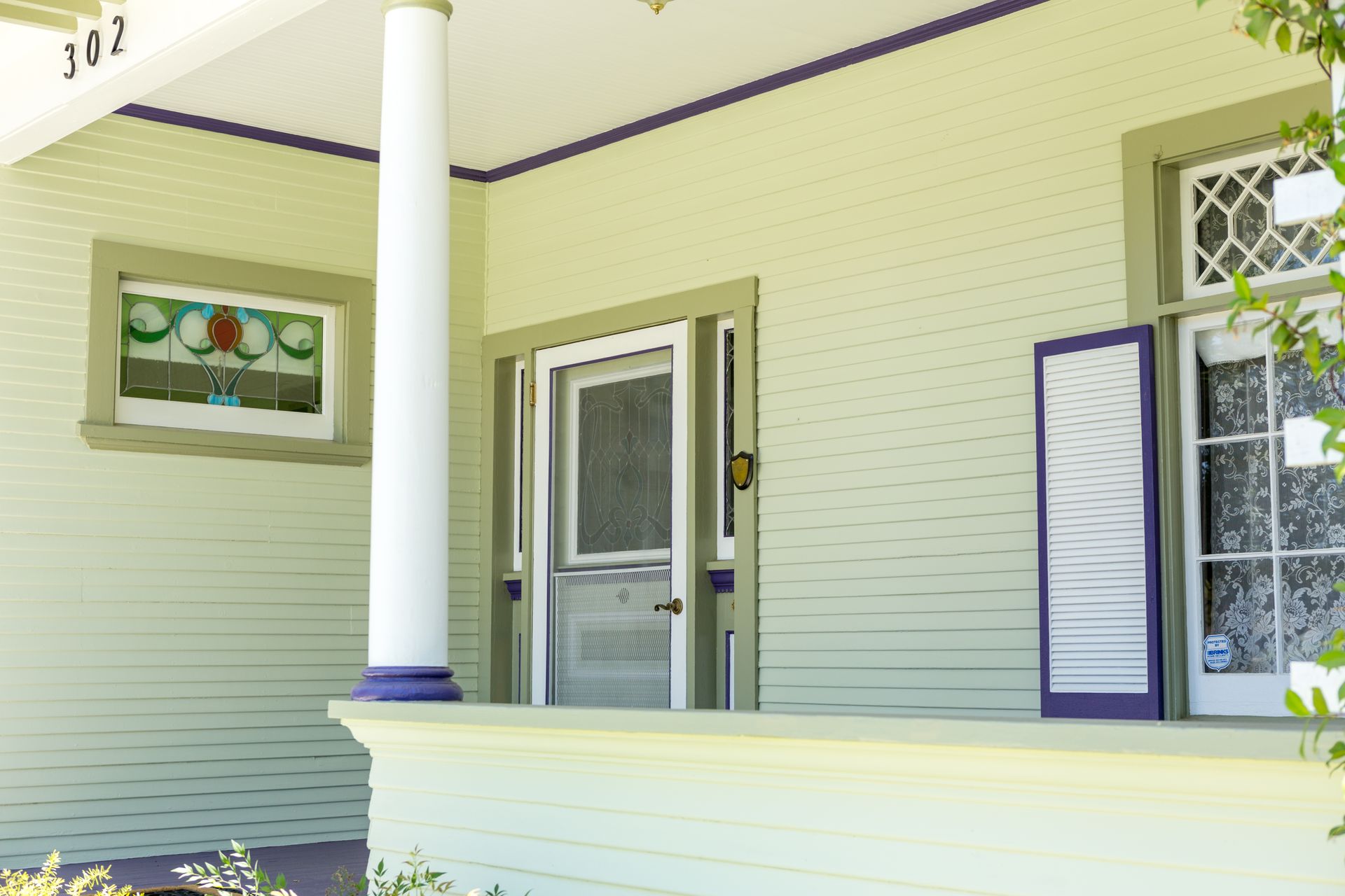 The front porch of a house with the number 102 on it