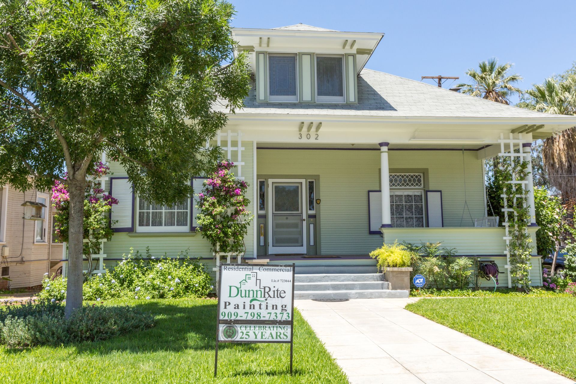 A house with a for sale sign in front of it